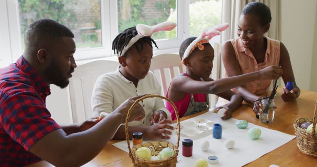 African american family painting easter eggs together at home - Download Free Stock Photos Pikwizard.com