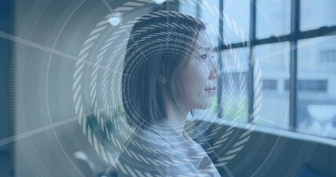 Asian woman gazing through office window with spiral overlay, contemplative profile