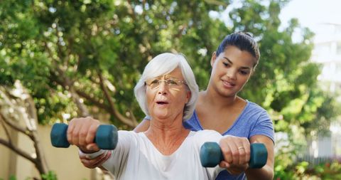 Senior Woman Practicing Outdoors with Young Trainer - Download Free Stock Images Pikwizard.com