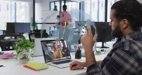 Mid-Adult Man Engaging in Virtual Meeting in Modern Office Setting
