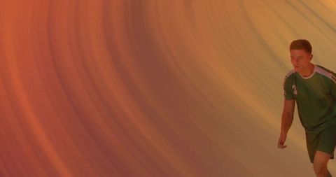 Athlete in Motion Against Vibrant Orange Backdrop