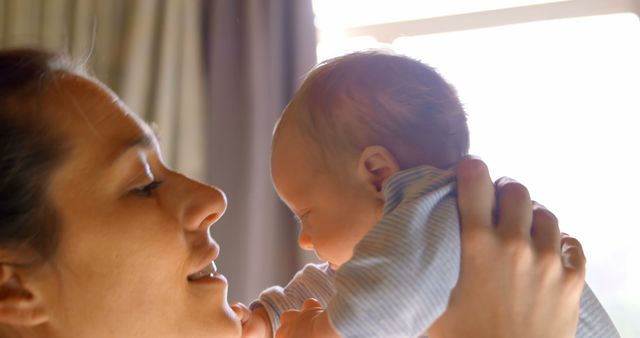 Mother Holding Newborn Baby by Sunlit Window - Download Free Stock Images Pikwizard.com