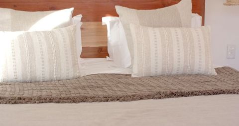 Cozy minimalist bedroom with warm textiles and wood accents