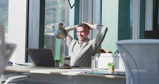 Businessman Relaxing at Desk in Modern Office - Download Free Stock Images Pikwizard.com