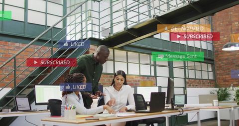 Diverse Team Collaborating with Social Media Notifications in Modern Office