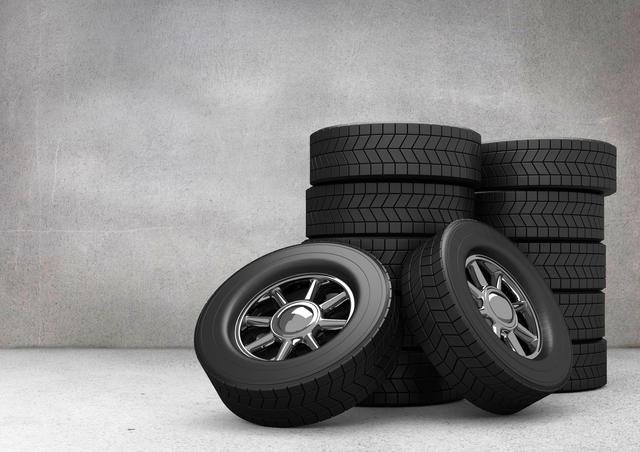 Stack of Car Tyres Against Grey Background in Garage - Download Free Stock Images Pikwizard.com