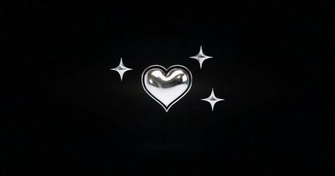 Silver heart with star bursts on black background