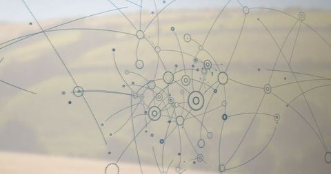Etched network decal glass overlooking blurred countryside fields, abstract connectivity