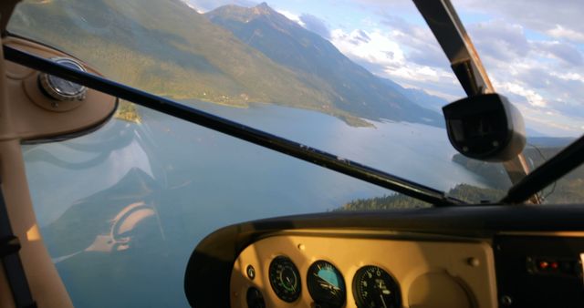 Cockpit view of seaplane flying over mountainous lake scenery - Download Free Stock Images Pikwizard.com