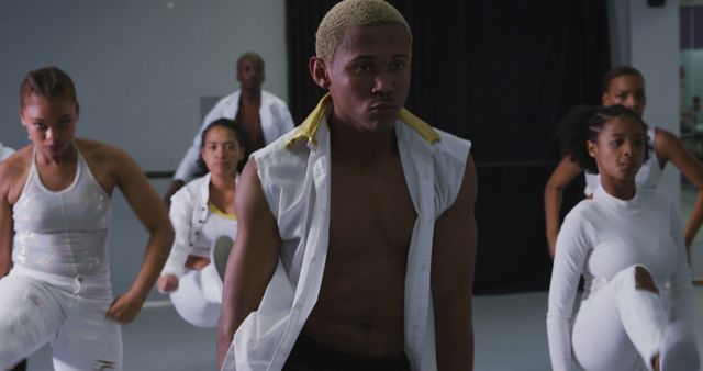 Group of dancers practicing routines in a dance studio. They are wearing fitness attire, appearing focused and determined, united by their passion for dance. Perfect for use in articles or advertisements about dance classes, fitness, teamwork, diversity, and dedication.