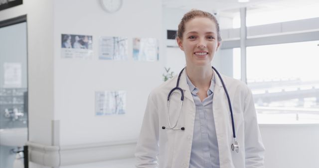 Smiling Female Doctor Standing in Bright Modern Hospital Corridor - Download Free Stock Images Pikwizard.com