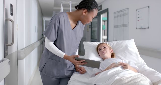 Nurse consulting young patient in hospital bed with digital tablet - Download Free Stock Images Pikwizard.com