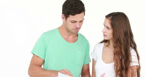 Young Couple Engaged in Serious Discussion Indoors