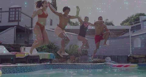 Friends jumping into backyard pool during summer party, joyful group splash in sunlit patio
