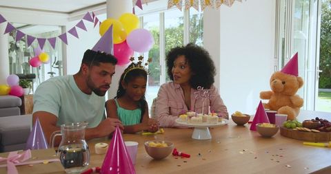 Family Celebrating Birthday with Cupcakes and Decorations