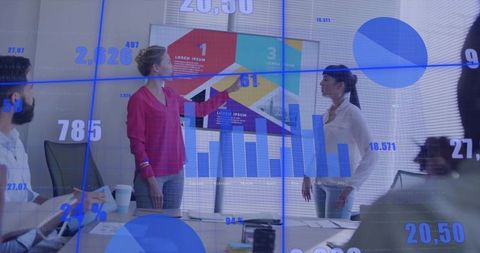 Presenter Highlighting Data in Modern Meeting Room with Analytics Visualization