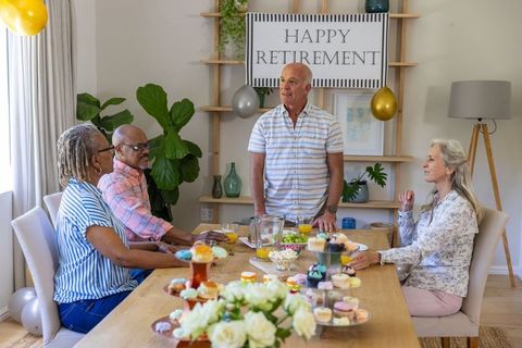 Senior friends celebrating retirement with decor and cupcakes