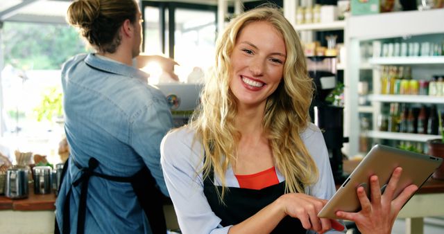 Young Barista Smiling and Using Digital Tablet in Modern Coffee Shop - Download Free Stock Images Pikwizard.com