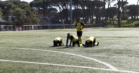 Soccer Team Practicing Together on Artificial Turf Field