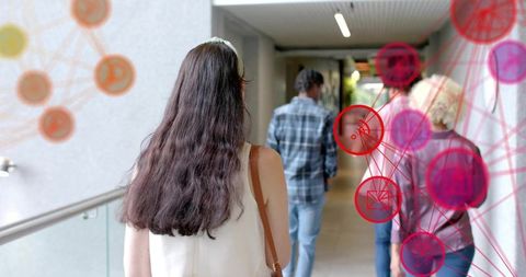 Walking through modern corridor with pink network overlay visualizing human connectivity