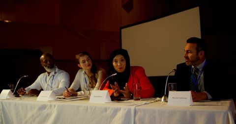 Diverse panelists discussing at business seminar