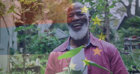 Gardening joy of a senior man amongst backyard greenery