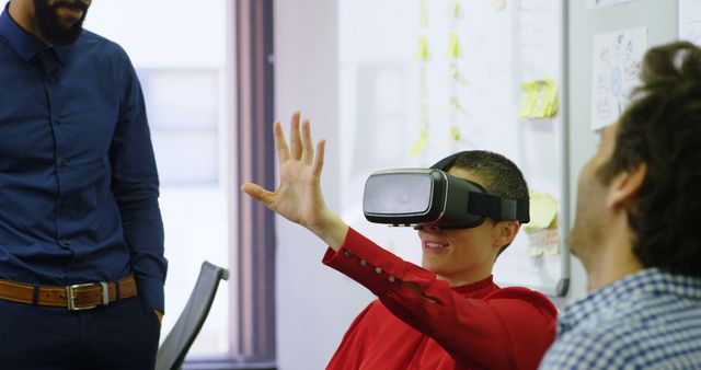 Person Wearing VR Headset Experiencing Virtual Reality in Office - Download Free Stock Photos Pikwizard.com
