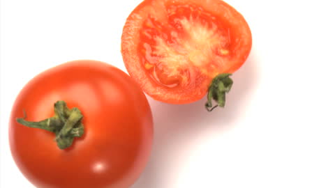 Fresh Whole and Sliced Tomatoes on Bright White Background