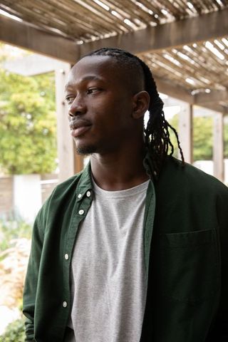 African American Man Under Pergola in Calm Garden Setting