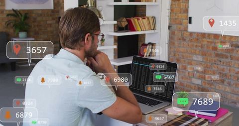 Developer coding with live notifications and location pins on laptop in modern workspace