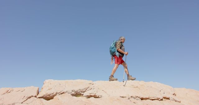 Man Hiking on Rocky Terrain in Desert Landscape - Download Free Stock Images Pikwizard.com