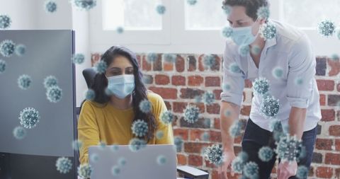 Colleagues working in office with virtual covid-19 virus overlays