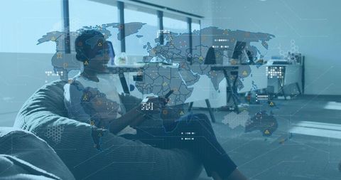 Remote data analyst lounging on beanbag using tablet with global map and data overlay