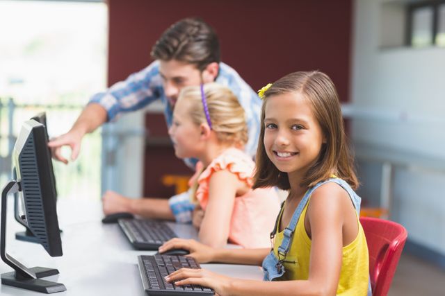 Schoolgirl using computer in classroom at school