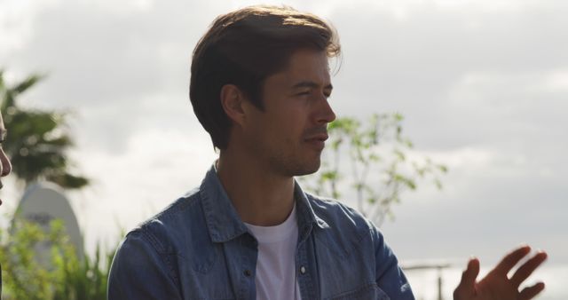 Confident Young Man in Denim Jacket Against Outdoor Background - Download Free Stock Images Pikwizard.com