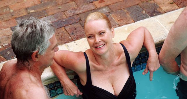 Senior friends are bonding and relaxing in a swimming pool, enjoying leisure time and good conversation. Perfect for illustrating fun social gatherings, health and wellness for seniors, or relaxing summer activities.