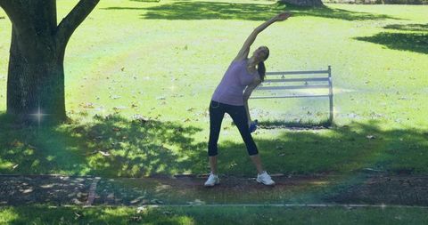 Woman Stretching in Park Promoting Wellness and Outdoor Fitness