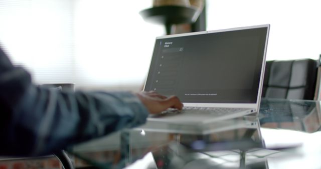 Person Using Laptop on Glass Table in Office Setting - Download Free Stock Images Pikwizard.com