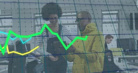 Colleagues reviewing tablet with data overlay in modern office boosting team collaboration