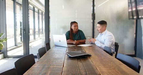Diverse Business Meeting with Agreement Signing in Modern Office