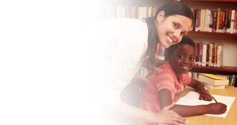 Positive Teacher Guiding Student in Library with Blank Space for Text