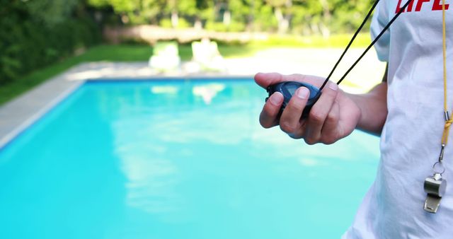 Lifeguard Holding Stopwatch by Swimming Pool - Download Free Stock Images Pikwizard.com