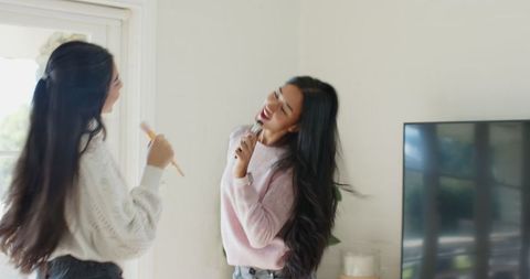 Diverse Female Friends Enjoying Home Karaoke Fun