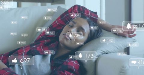 Woman Resting on Couch with Digital Media Icons Overlay