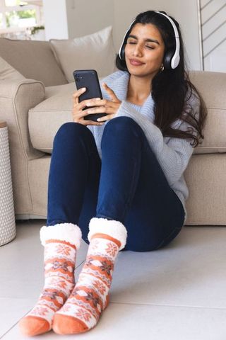 Cozy Relaxation with Asian Woman Enjoying Music at Home