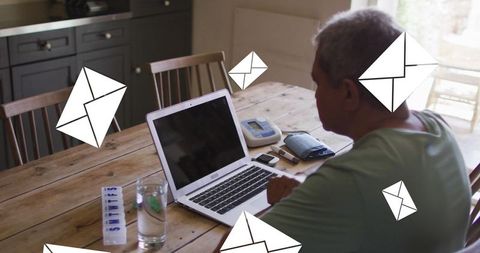 Senior man engaging with digital communication at home