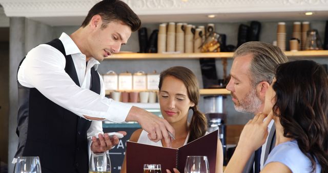 Waiter Taking Order from Business Team in Casual Restaurant - Download Free Stock Images Pikwizard.com