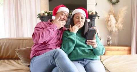 Festive Couple Sharing Holiday Cheer in Cozy Living Room