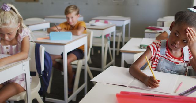 Diverse elementary schoolchildren focused during classroom activities - Download Free Stock Images Pikwizard.com