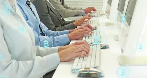 Colleagues Engaging in Bitcoin Transactions at Office Workstations